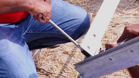 Worker-Using-Socket-Wrench-To-Tighten-Parts-Of-Center-Pivot-irrigation-Together-In-Sindh