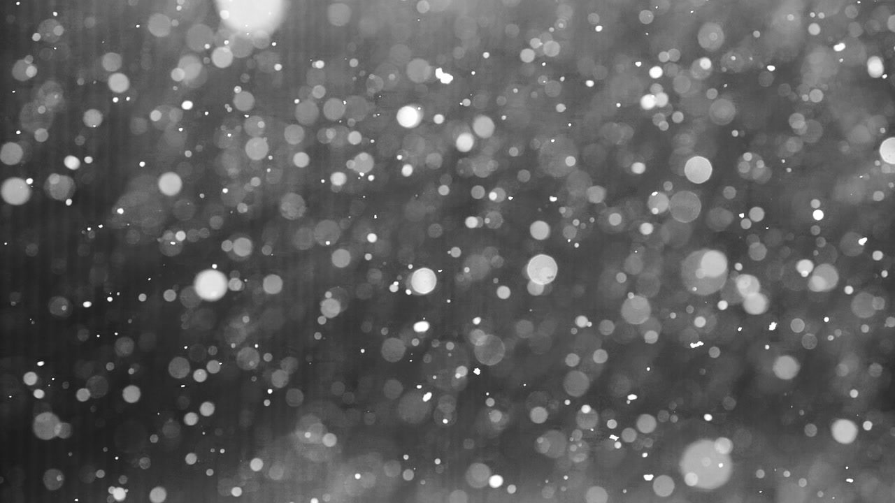 Romantic snowfall captured in cinematic slow motion with bokeh background