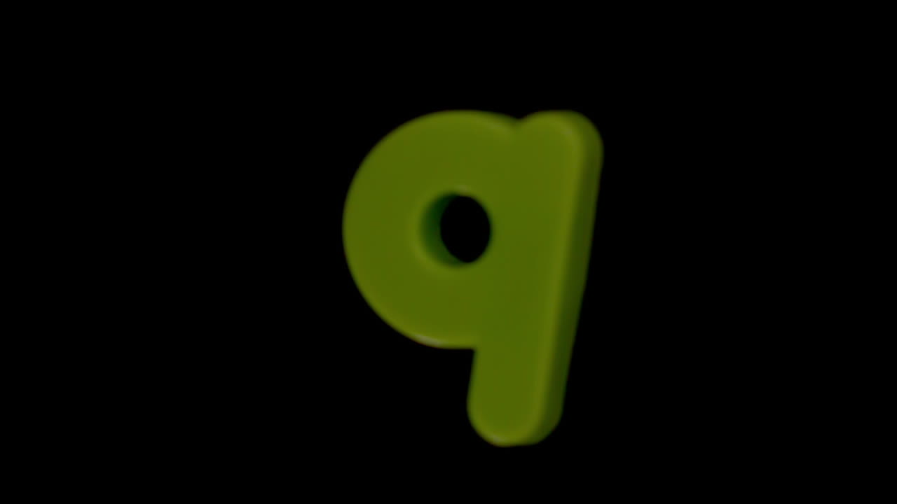 The letter q coming into focus on black background