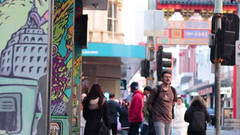 people crossing street near traffic light in melbourne