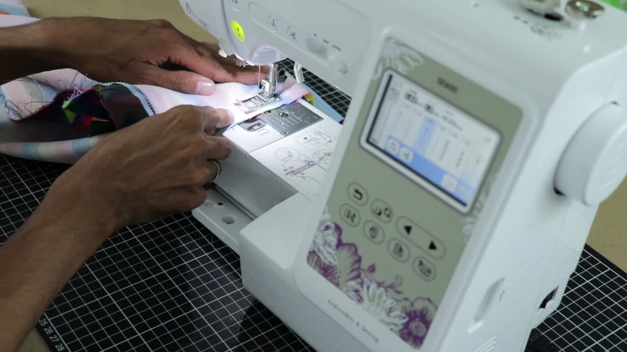 Latin person sewing clothes with a machine