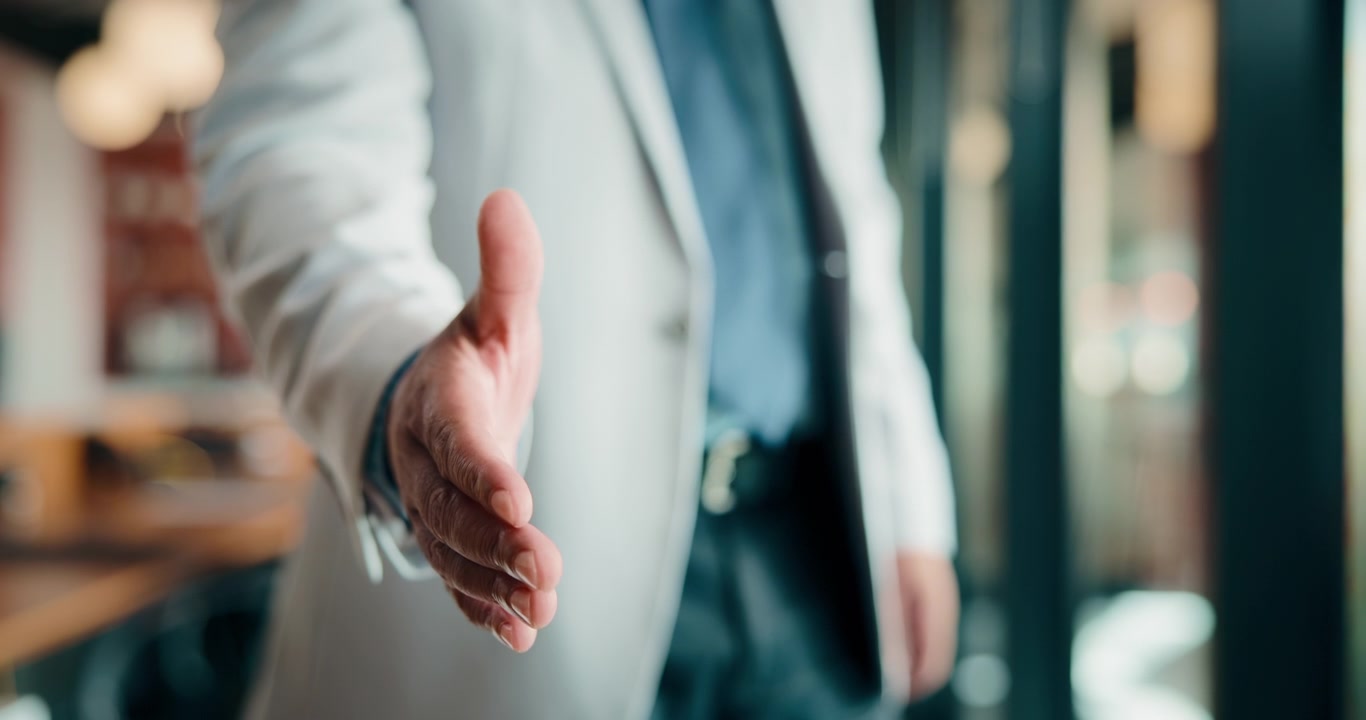Businessman Offering a Handshake in a Professional Office Setting