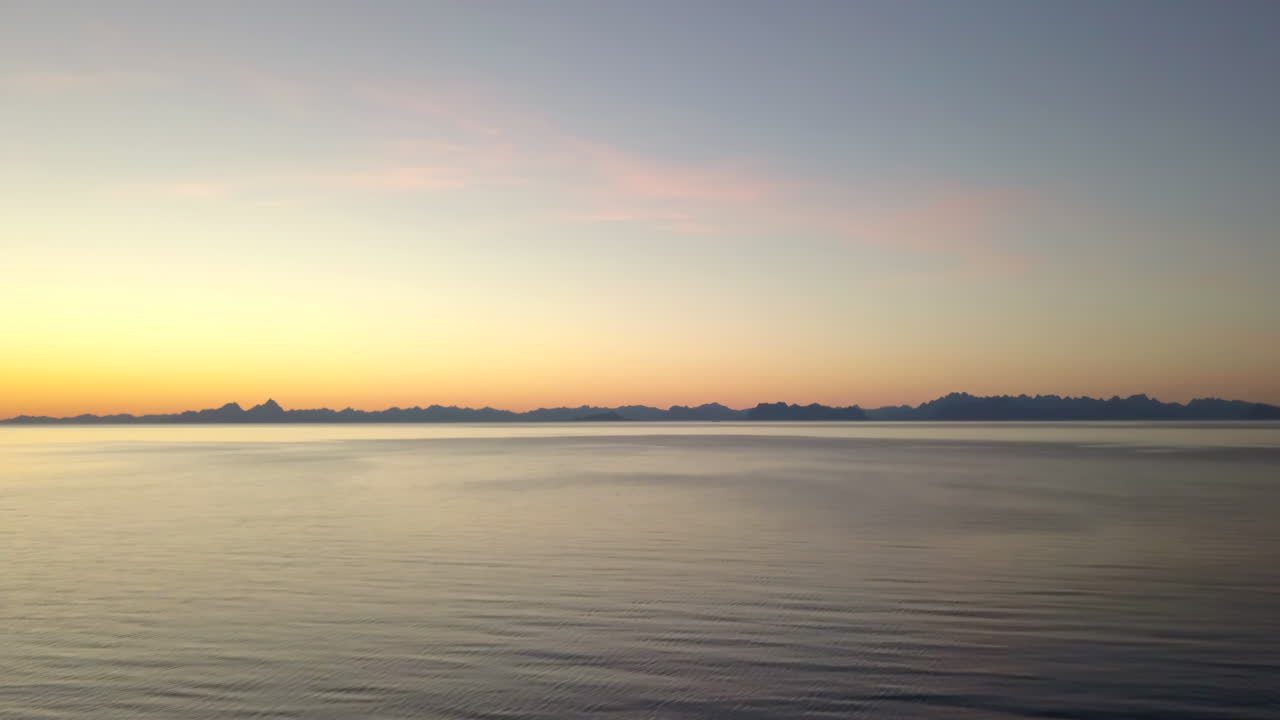 Aerial shot of beautiful sunset on crystal white beach in the north of Norway. Shot at Bøsanden in Steigen, with a view of Lofoten.
