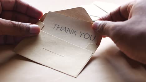 close up of man hand reading a thank you letter