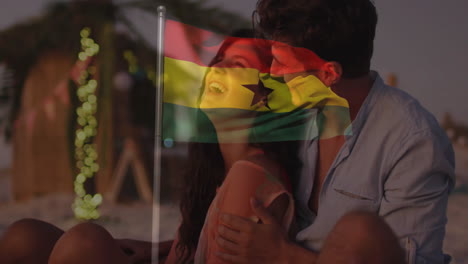 on beach, couple embracing with ghana flag animation overlaying scene