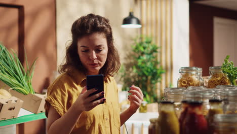 Woman-using-cellphone-in-eco-store