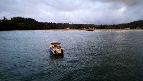 zoom into hanalei bay pier over boat on cloudy day