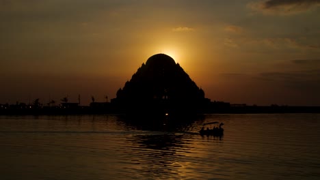 sun setting behind makassar temple