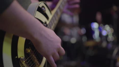 close-up of a guitarist playing on stage