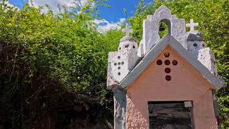 miniature roadside shrine amidst lush greenery