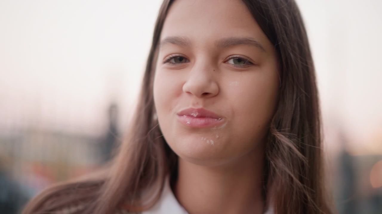 Young Girl Eating a Sweet Pastry Outdoors