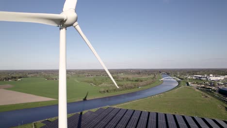 Clean-energy-wind-turbines-and-solar-panels-hub-in-The-Netherlands-with-Twentekanaal-inland-shipping-waterway-infrastructure-in-the-background