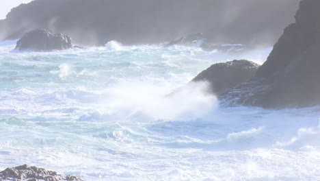 powerful ocean waves crashing against rocks