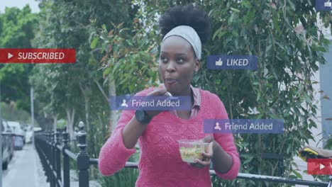Animation-of-social-media-notifications-over-african-american-woman-eating-takeaway-in-city-street