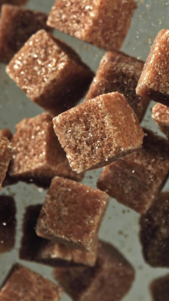 Brown Sugar Cubes Floating and Falling in Slow Motion Close-up