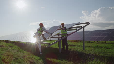 robot and worker installing solar panels