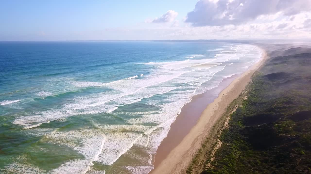 High and descending aerial footage of waves and beach at Venus Bay, Victoria, Australia