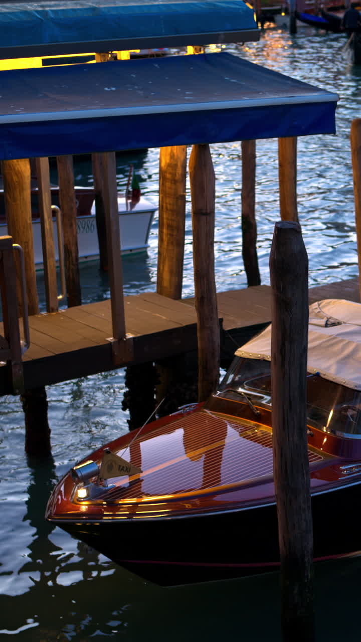 Close up of a boat docked in Venice, Italy near the Grand Canal at sunset. Vertical, Venice, Italy