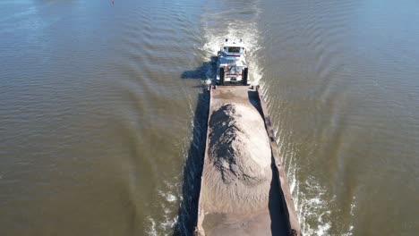 A-towboat-pushes-a-single-barge-of-dirt-north-on-the-Mississippi-River-past-Lansing,-Iowa-3