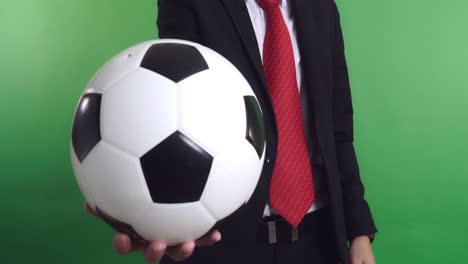 businessman holding a soccer ball, video in 4k