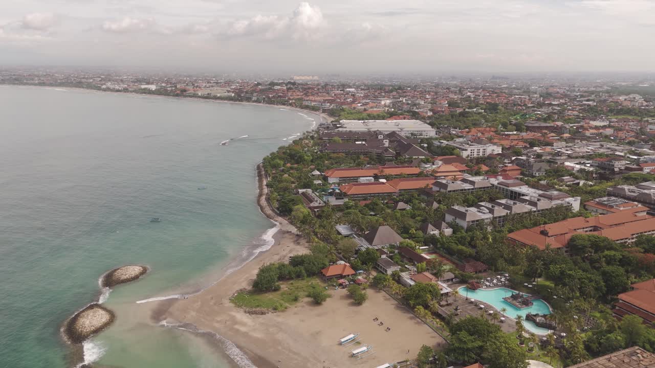 Drone Aerial View Over Kuta, Bali – Capturing Luxury Resorts and Residential Properties Amidst Stunning Tropical Scenery.