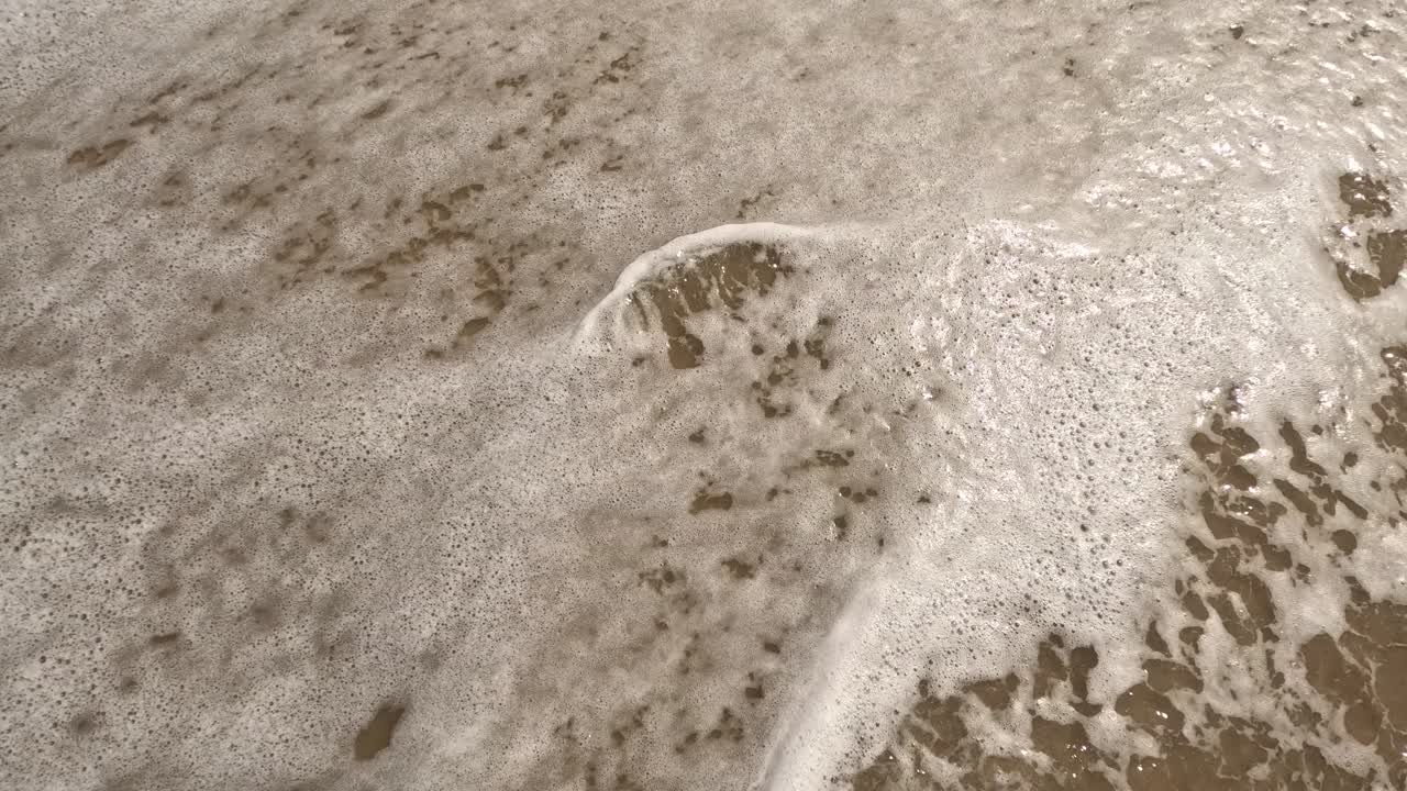 &amp;quot;Stress&amp;quot; word is written on the beach sand and erased with a wave, a concept video of relaxation and stress relief