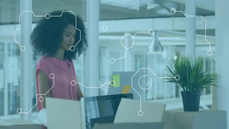 working at desk, businesswoman using laptop with digital animation overlay