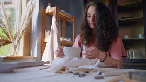 woman artist creating pottery