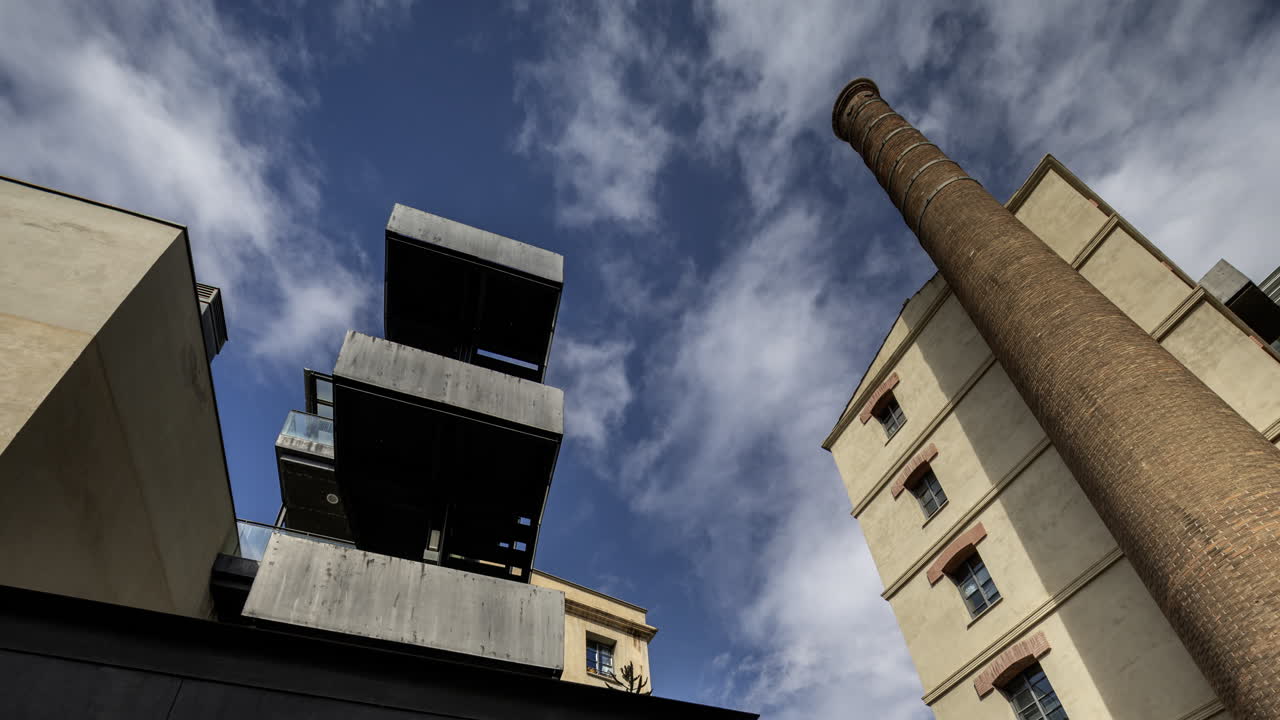 Old factory chimney and apartment buildings in barcelona