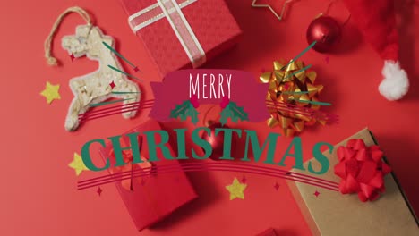 Animation-of-merry-christmas-text-over-christmas-decorations-and-presents