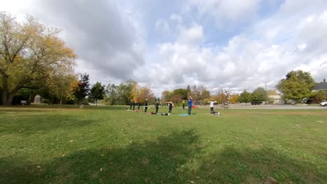 fall season timelapse of people doing yoga in a park