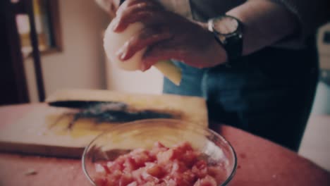 hands close up cutting a onion in small pieces to make salad