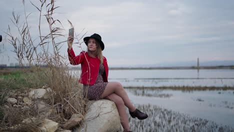 woman taking selfie by the lake