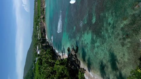 Vertical---Volando-Sobre-La-Costa-De-La-Playa-El-Quemaito-Con-Mar-Turquesa-En-Barahona,-República-Dominicana