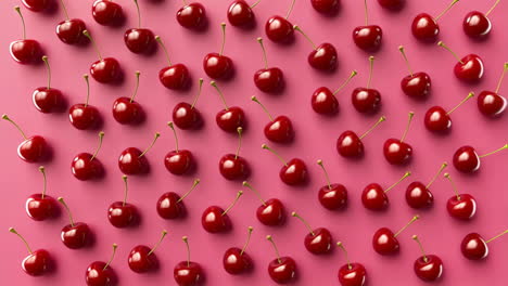 pattern of red cherries on a pink background