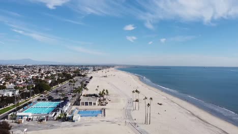 drone shot over beach and a swimming pool