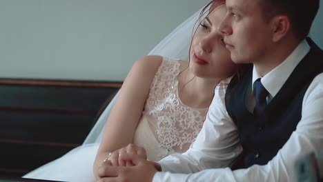 newlyweds sitting in a cafe and looking out the window close-up slow motion