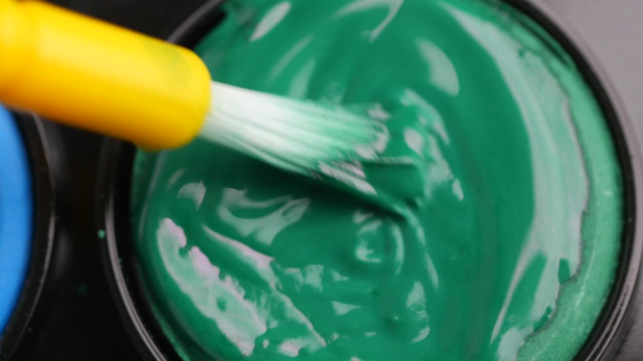 Green Paint Being Applied with a Brush