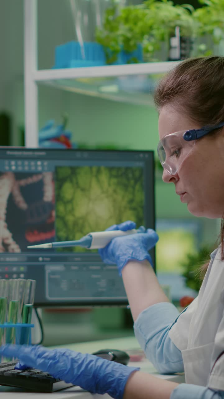 Woman Scientist Conducting Research with Pipette and Computer in a Lab
