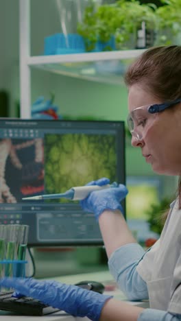 woman scientist conducting research with pipette and computer in a lab