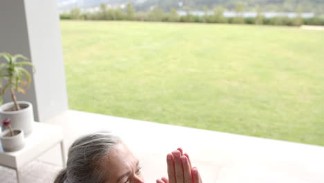 caucasian woman with grey hair looking outside