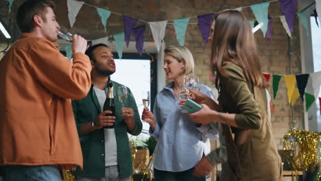 businesspeople celebrating company birthday standing at festive decorated office