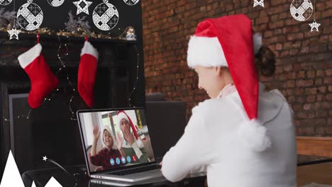 Animation-of-christmas-decorations-over-caucasian-girl-in-santa-hat-on-laptop-video-call-with-family