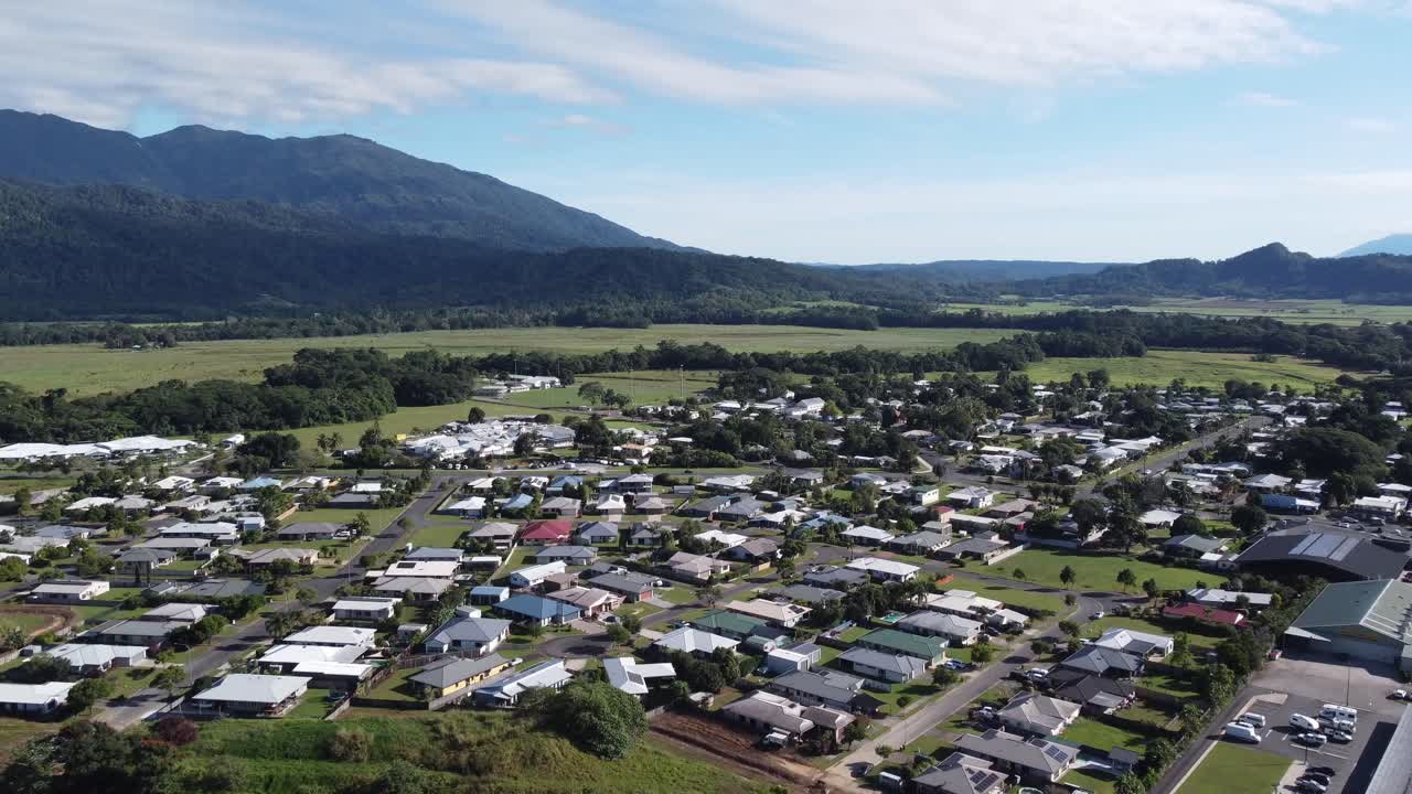 4K Aerial view of a small rural town near a sugarcane plantation in North Queensland, Australia