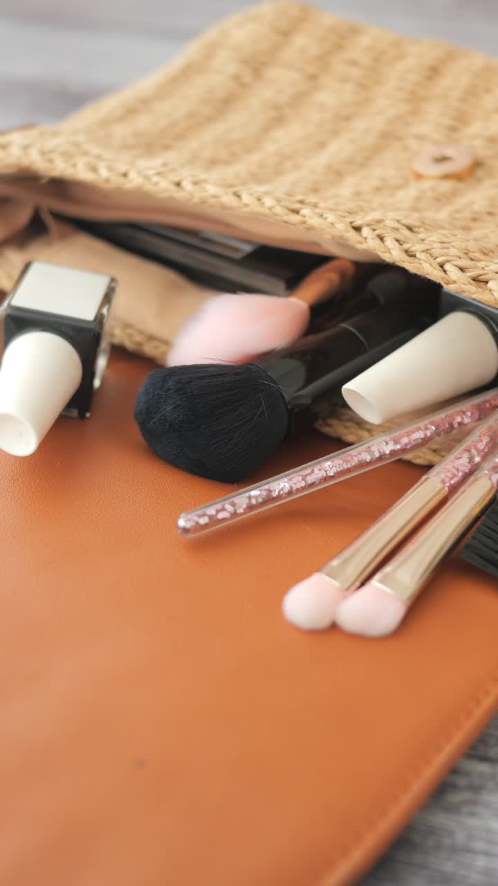 Close-up of Makeup Brushes and Cosmetics in a Woven Bag