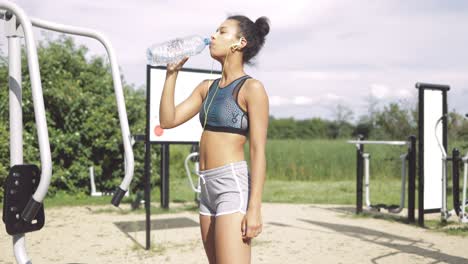 sporty girl drinking at workout