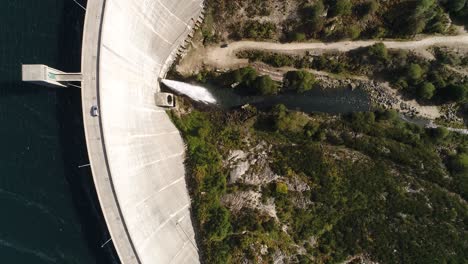 Car-Travel-in-an-electric-station-dam-Road-Aerial-View