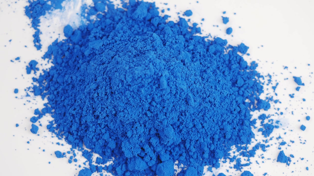 Vibrant Blue Pigment Powder on White Background