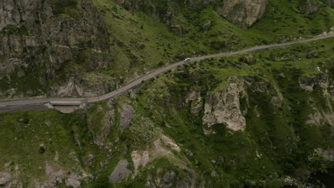 Vehicle-Traveling-On-The-Road-To-Vardzia-Near-Ruined-Fortress-Of-Tmogvi-In-Samtskhe-Javakheti,-Georgia