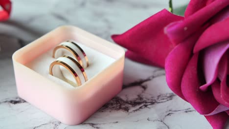 rose gold and white earrings in a pink box